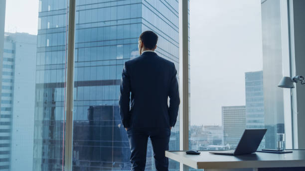 Businessman in office looking out